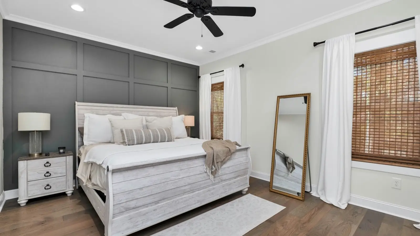 A ceiling fan above a bed in a bedroom.